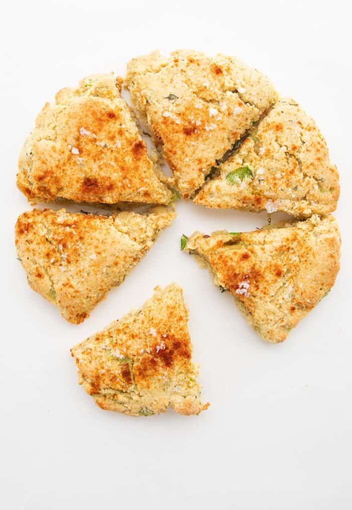 Top down image of ricotta herb scones on a white background.
