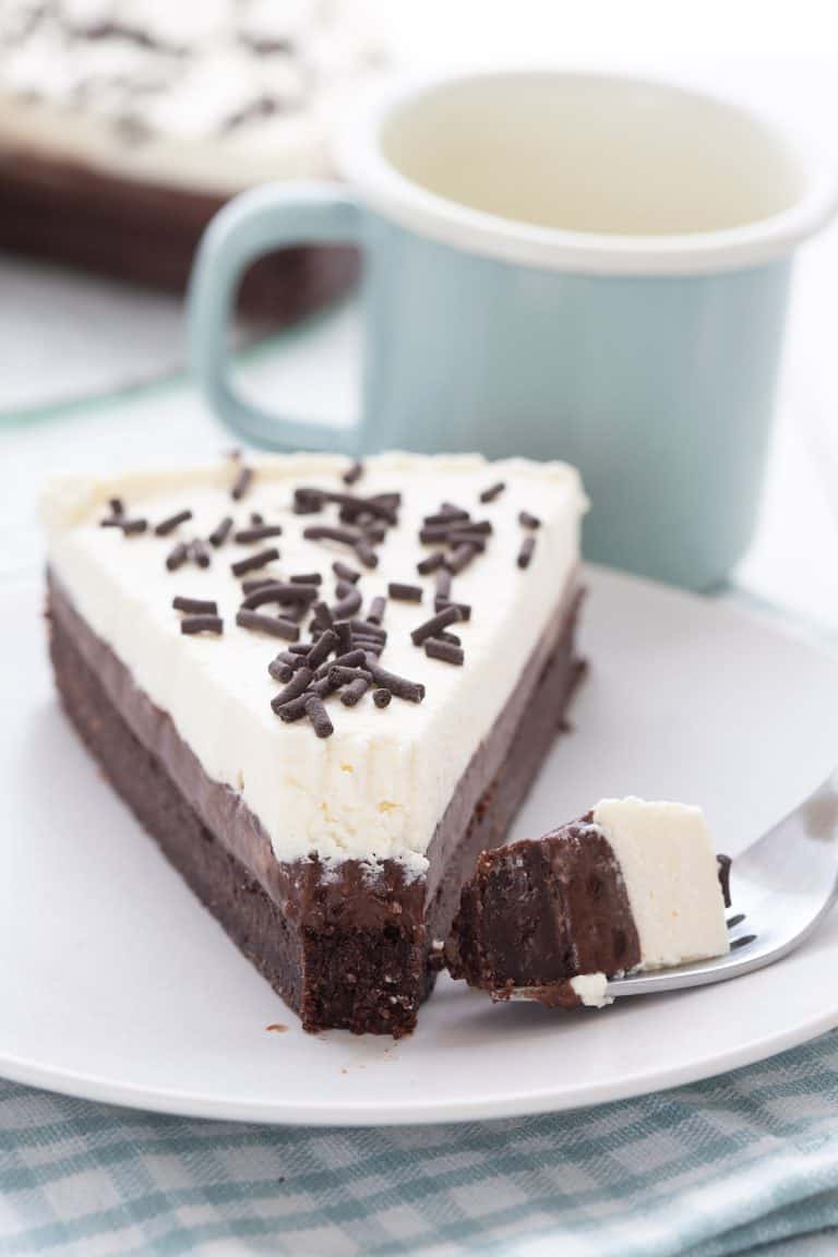 Close up shot of Keto Mississippi Mud Pie on a white plate with a forkful taken out of it.