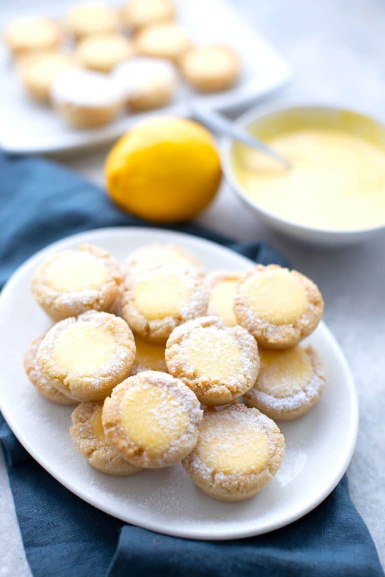 A white oval plate filled with keto lemon bar cookie cups.