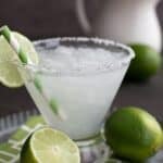 Titles image of a sugar free keto margarita on a metal platter with limes.