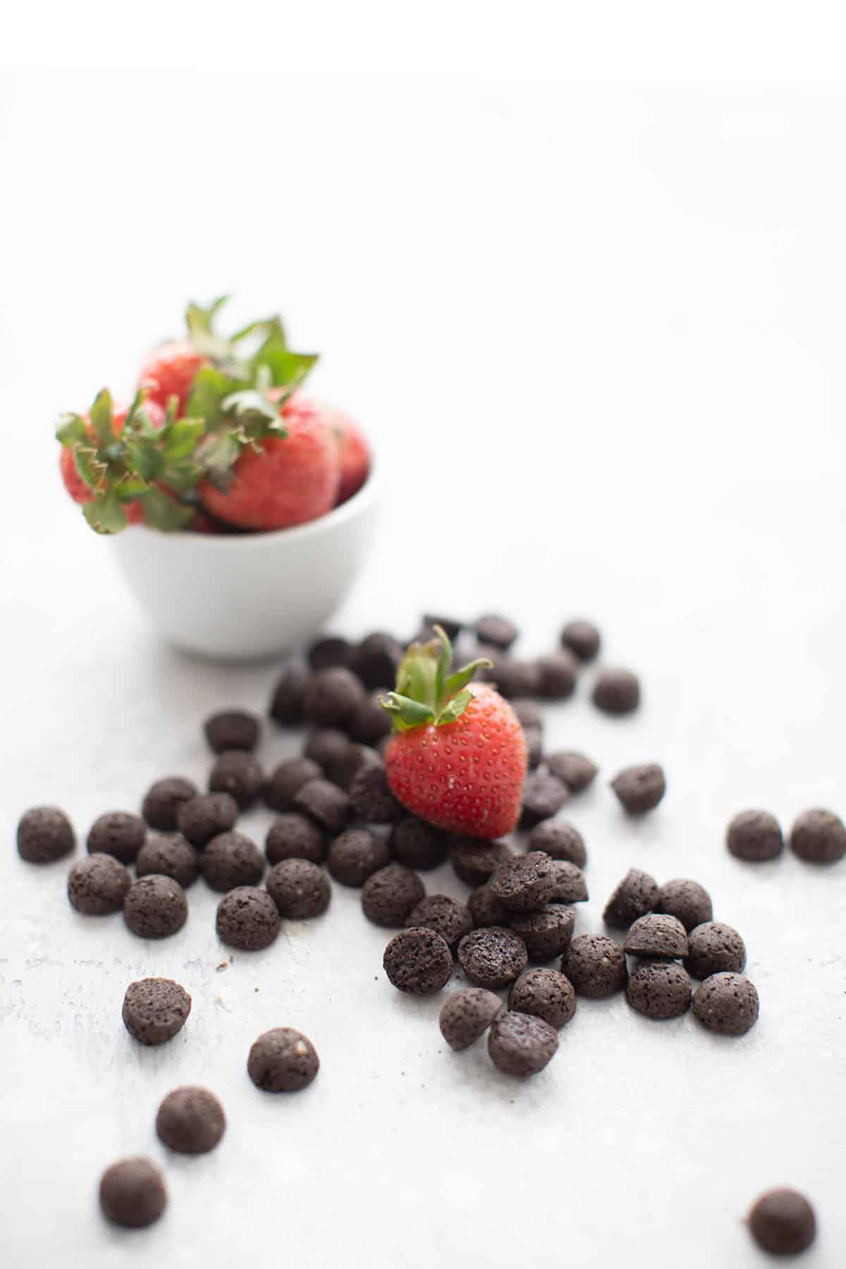 Keto chocolate cereal in a pile with a strawberry on top.