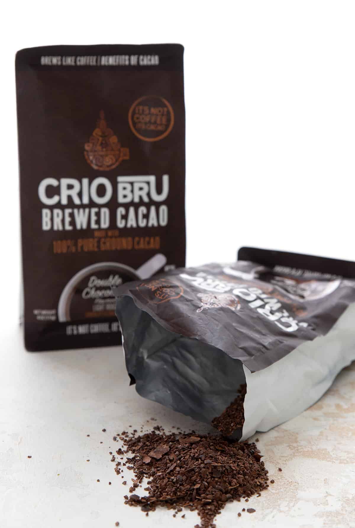 An open bag of Crio Bru with the ground cacao spilling out of it.