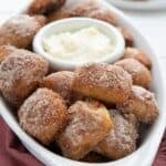 Titled image of Keto Cinnamon Pretzel Bites in an oval white dish over a red napkin.