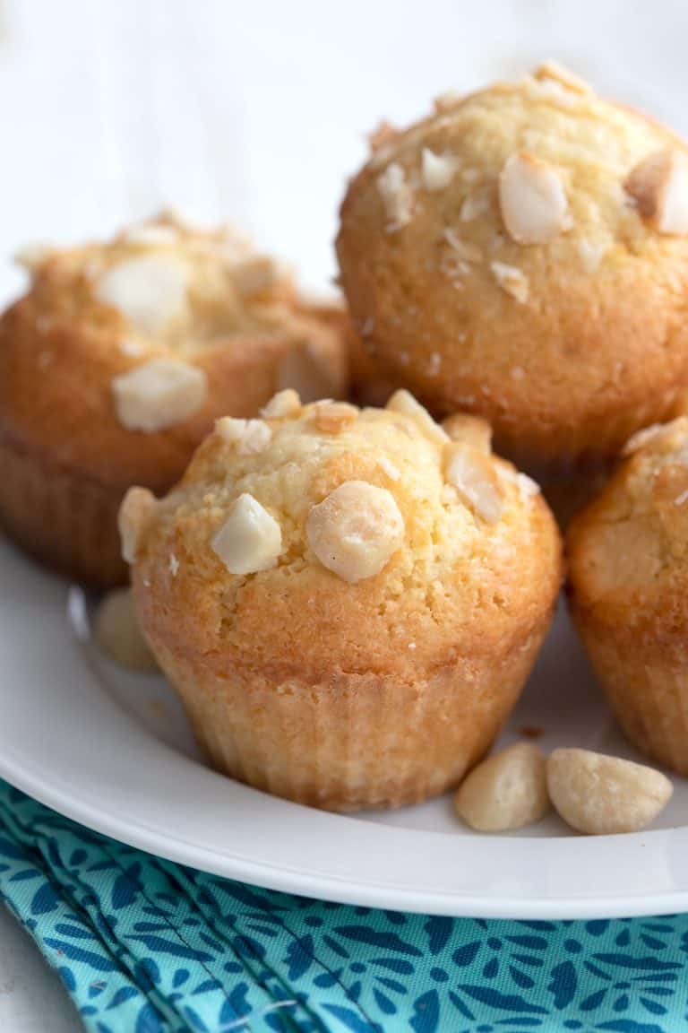 Close up shot of keto macadamia nut muffins on a white plate.