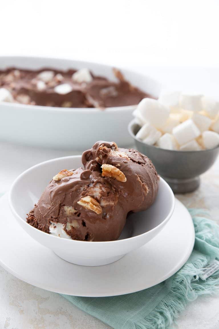 A white bowl of keto rocky road ice cream over a teal napkin.