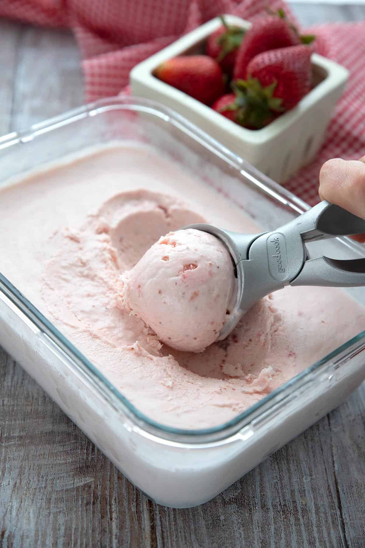 Sugar Free Strawberry Ice Cream being scooped out of a glass container.