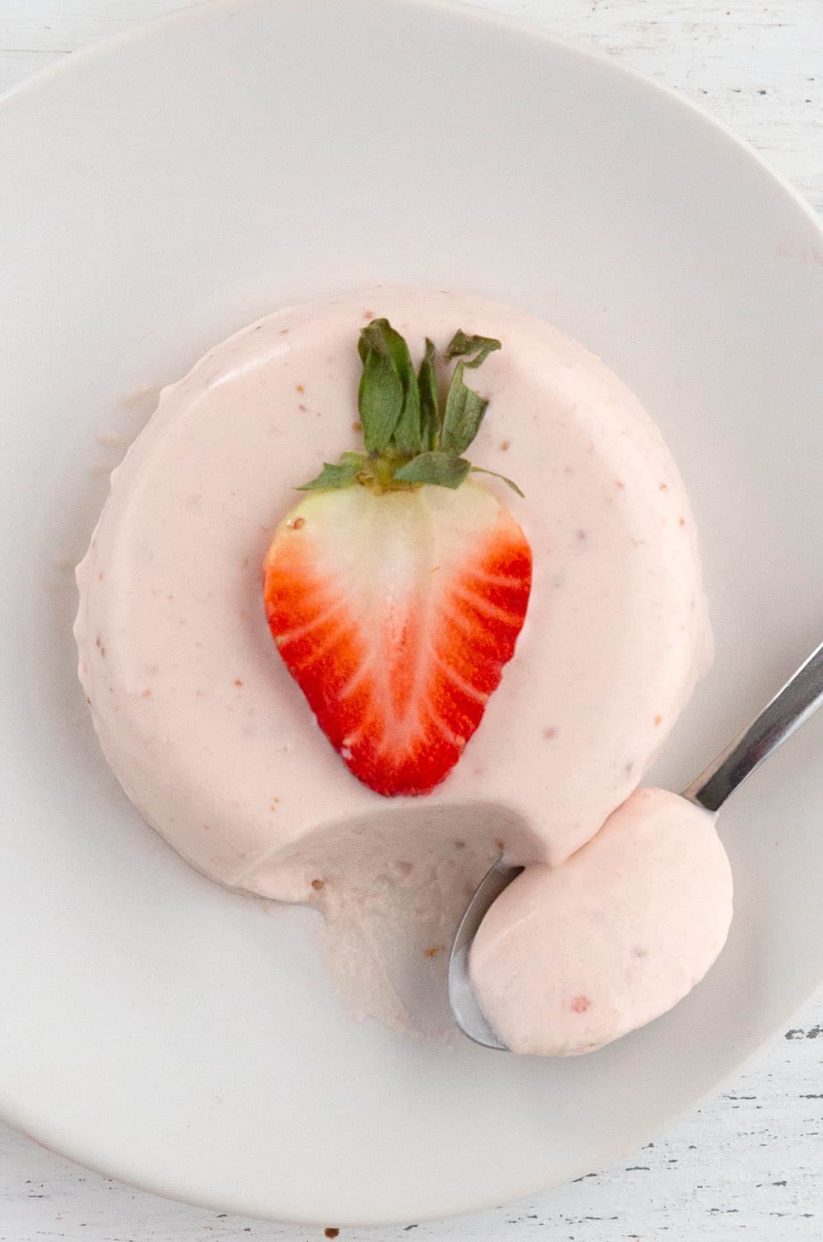 Top down image of Keto Strawberry Panna Cotta with a strawberry on top.