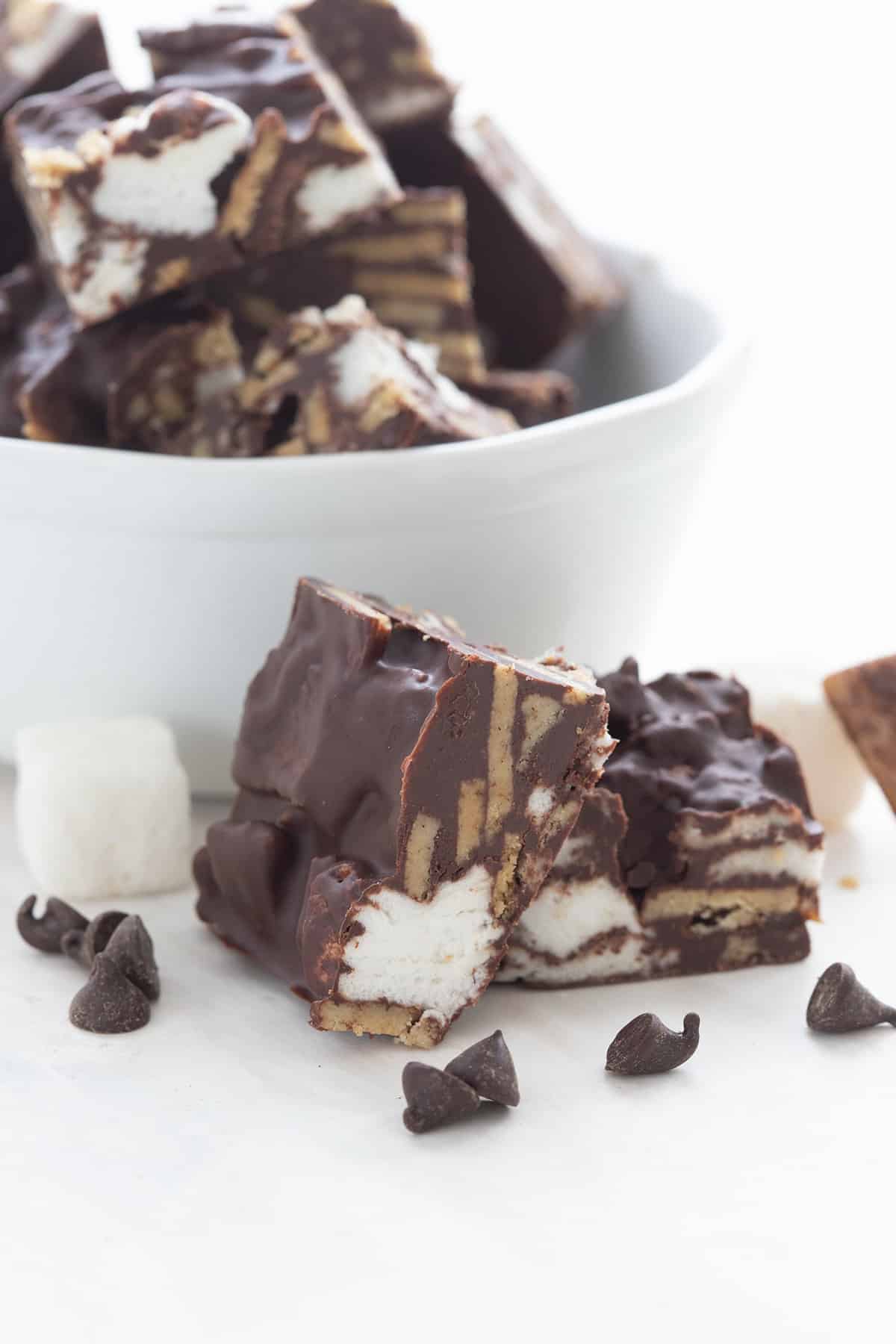 Two Keto Smores Bites in front of a white bowl with more bites.