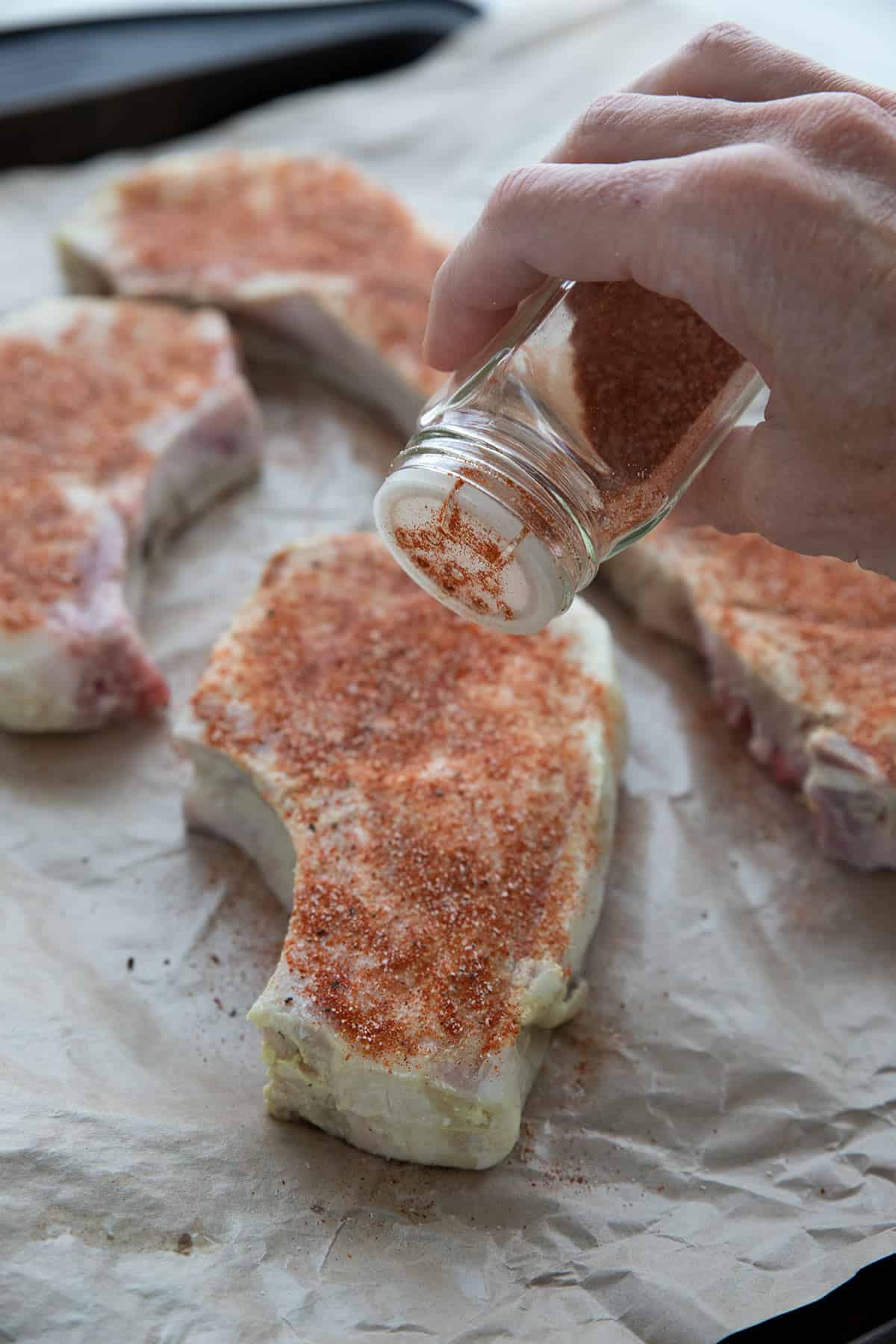 Sprinkle the pork chops with the seasoning.