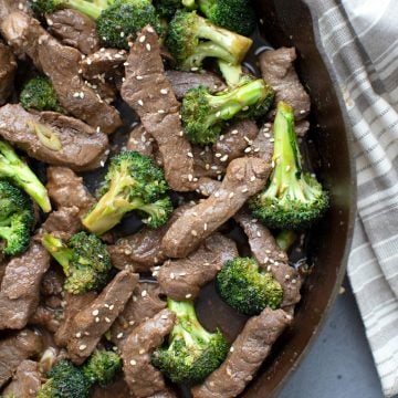 Top down image of keto beef and broccoli in a cast iron skillet.