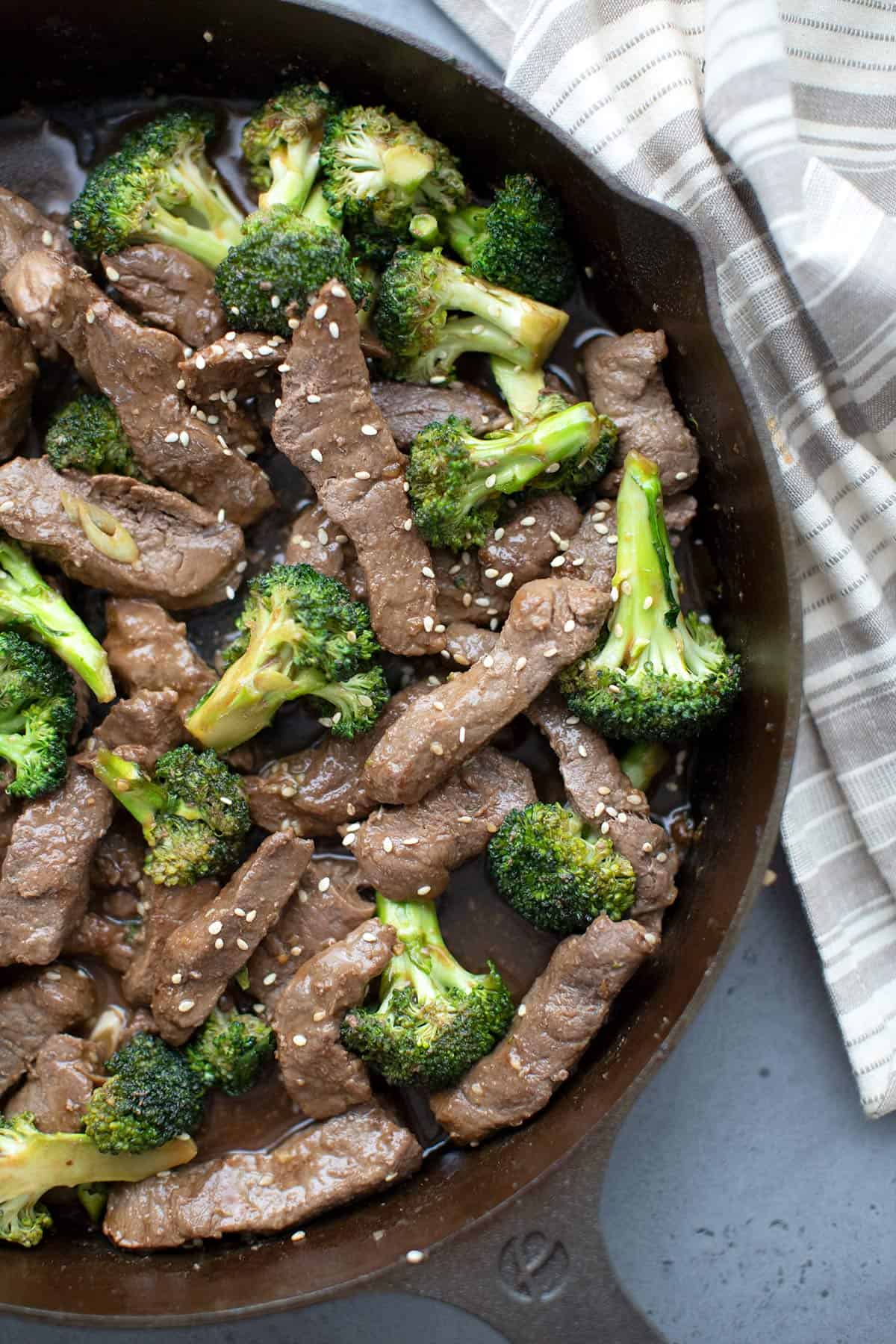 Top down image of keto beef and broccoli in a cast iron skillet. 