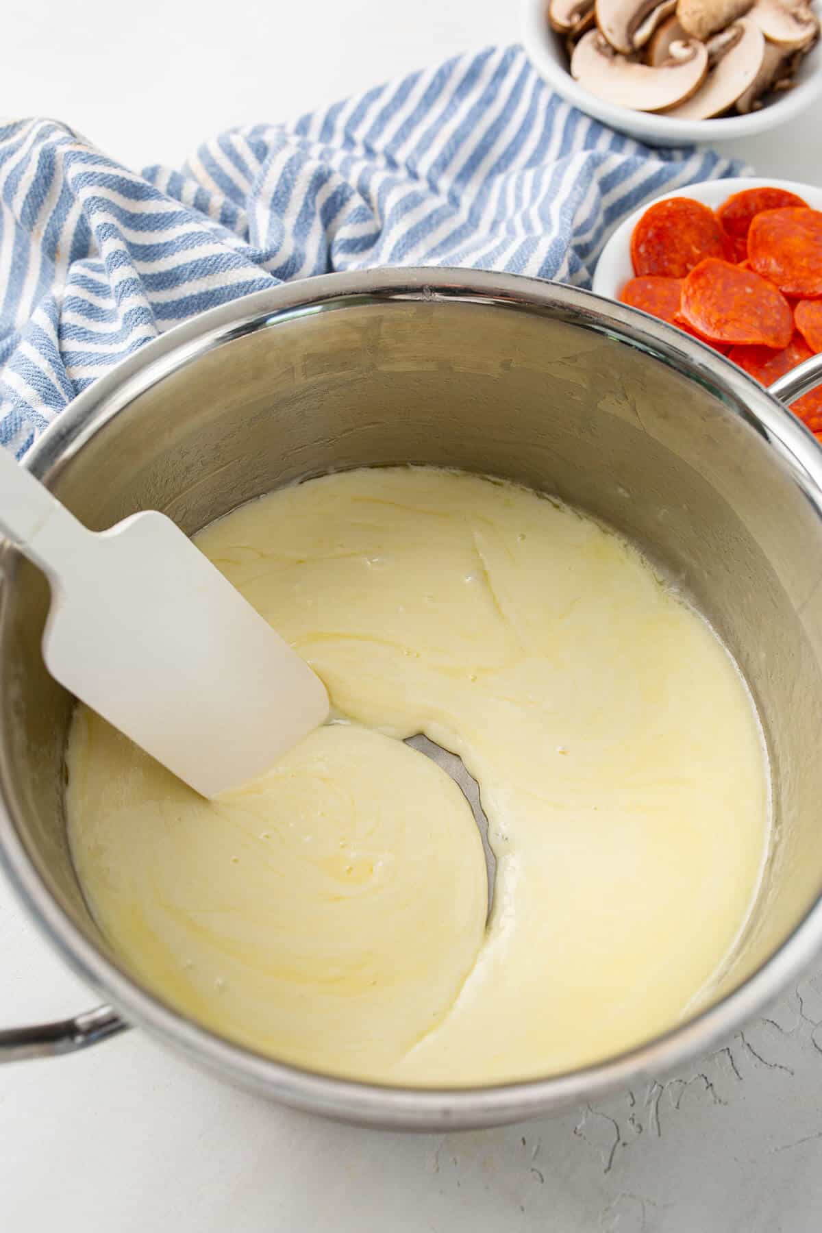 Melting butter and mozzarella cheese in a metal bowl to make fathead dough