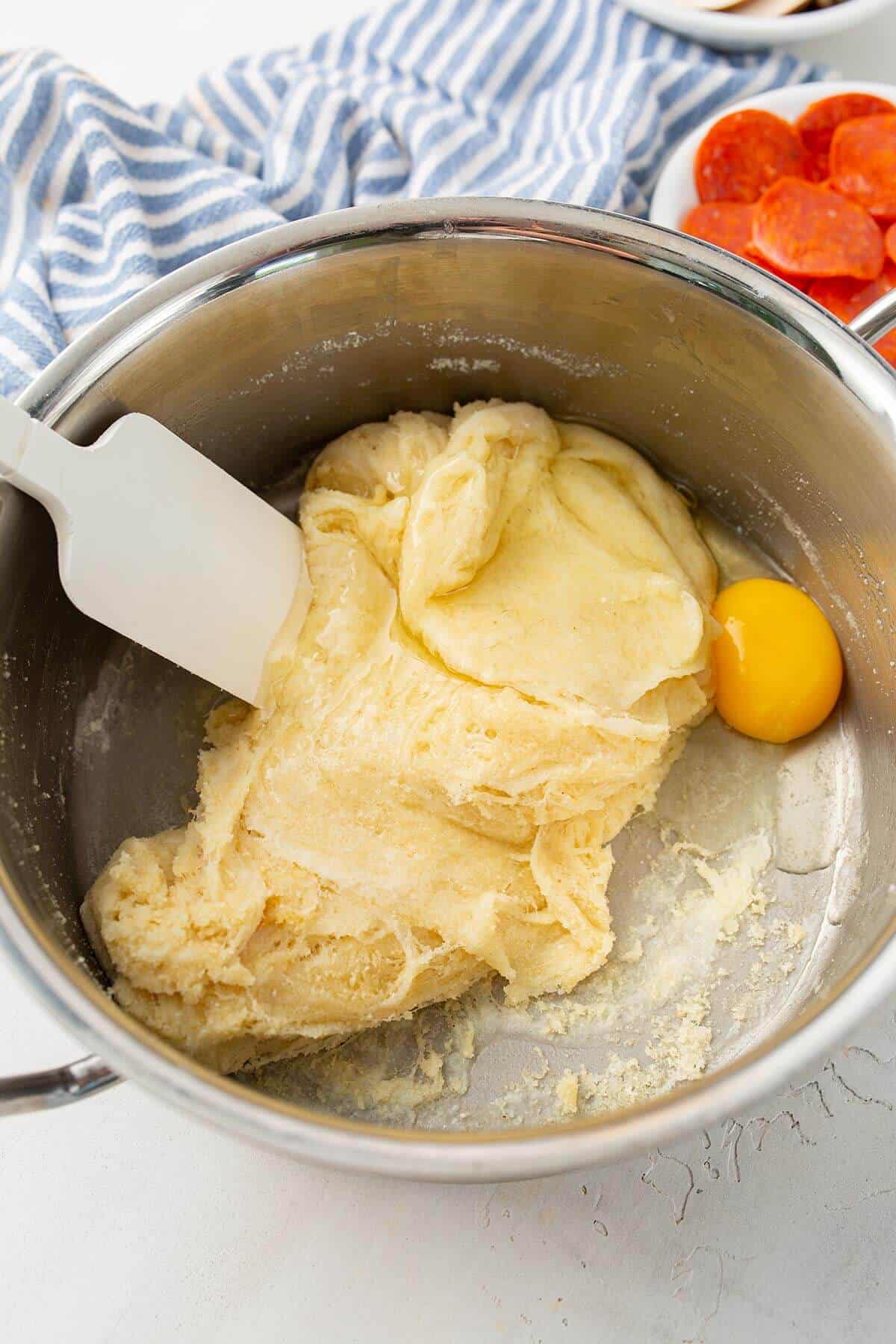 Mixing fathead dough in a metal bowl
