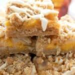 Titled Pinterest image of a stack of Keto Peach Cobbler Bars.