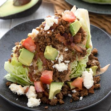 Close up shot of a Keto Taco Salad on a black plate.