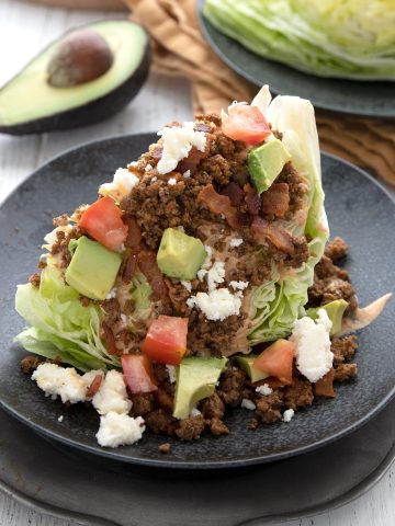 Close up shot of a Keto Taco Salad on a black plate.