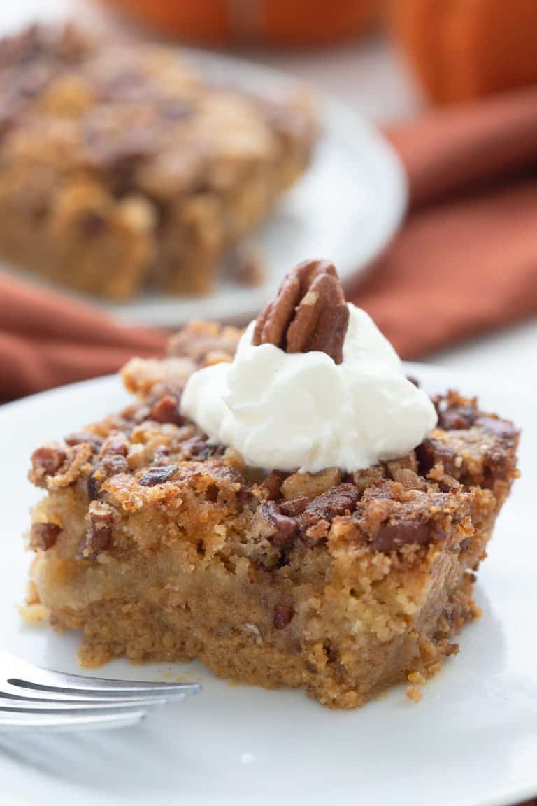 Close up shot of Keto Pumpkin Crunch Cake on a white plate.