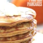 Close up shot of coconut flour pumpkin pancakes with syrup dripping down the side.