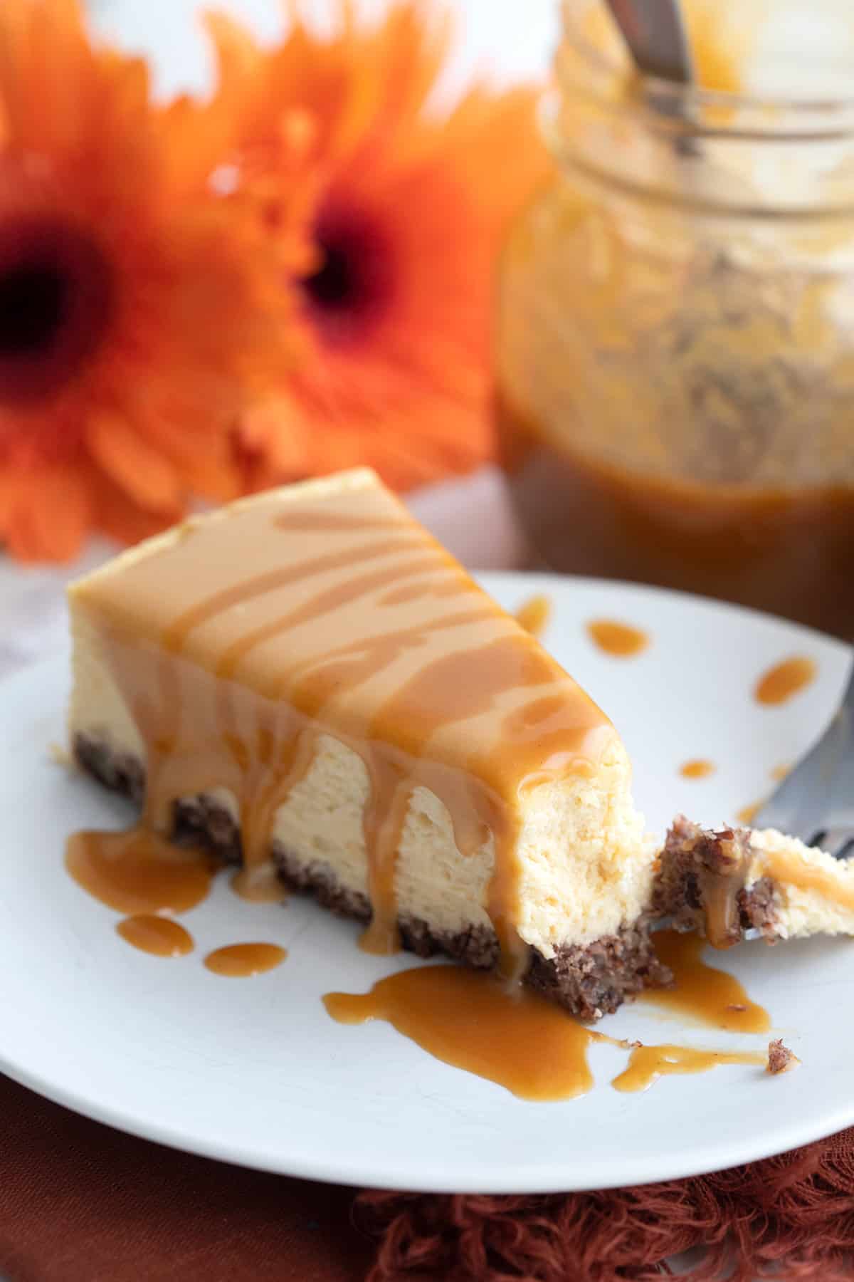 Close up shot of Dulce de Leche Cheesecake with a forkful taken out of it.
