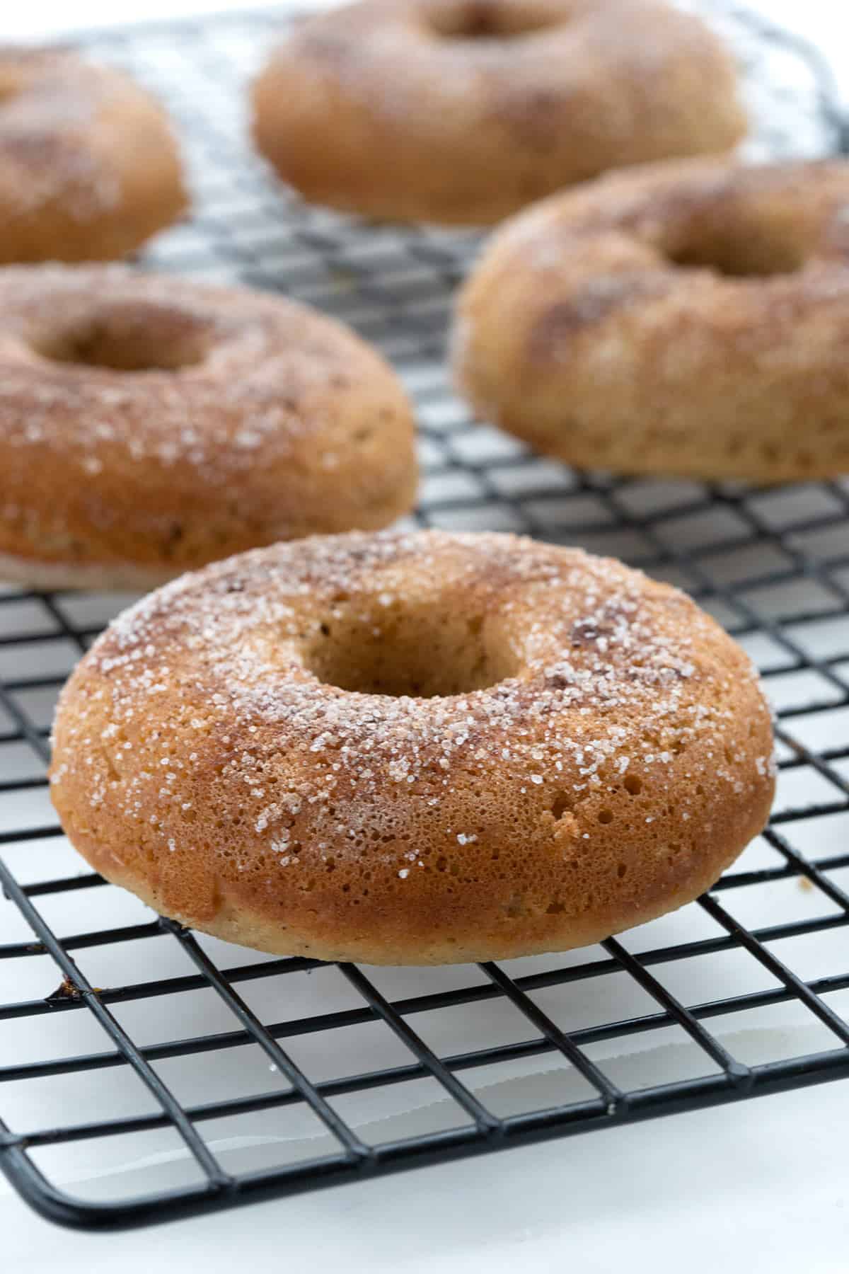 Keto almond flour donuts on a cooling rack.