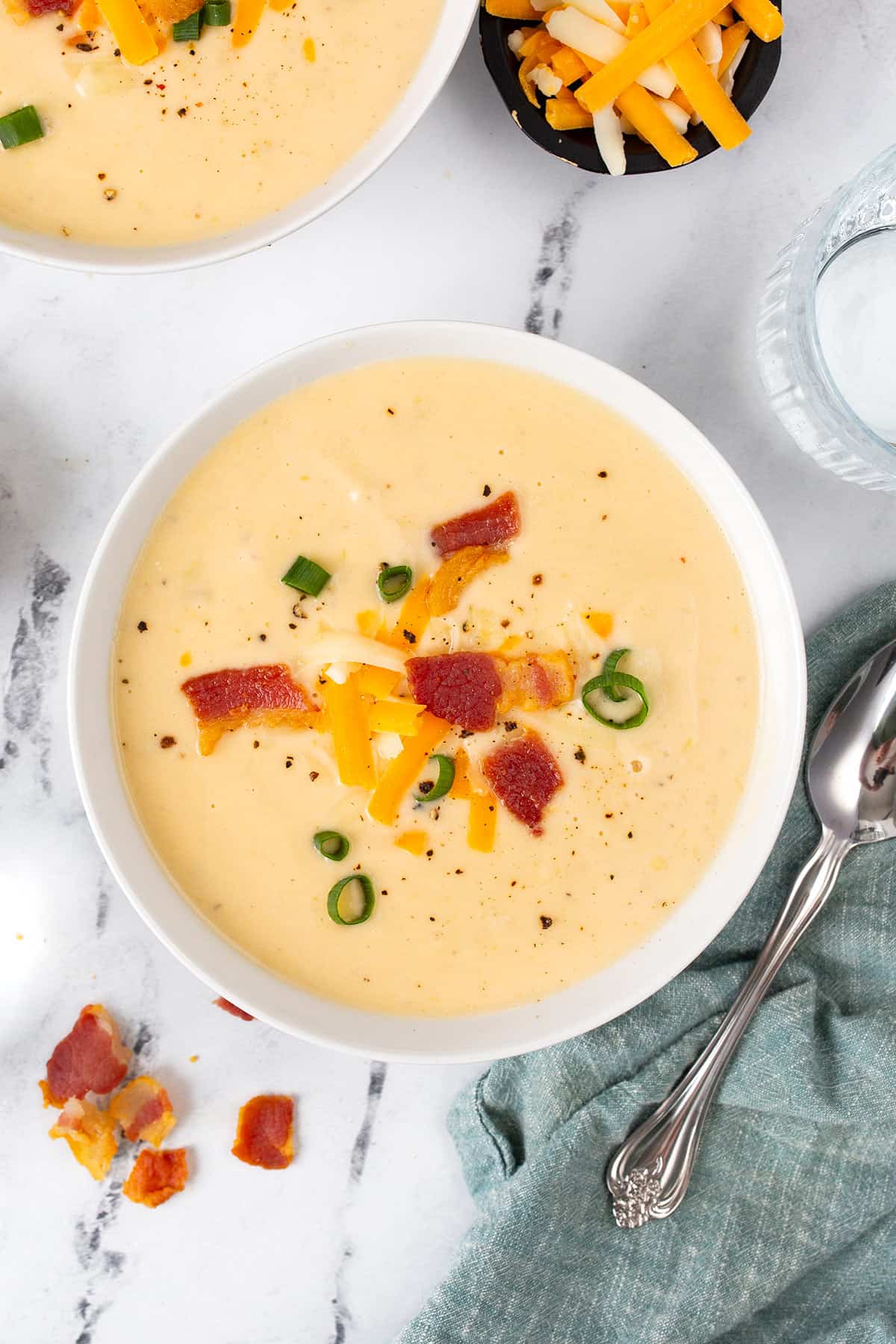 Top down image of keto cauliflower soup in a white bowl.
