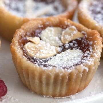 Close up shot of keto jam tarts on a white plate.