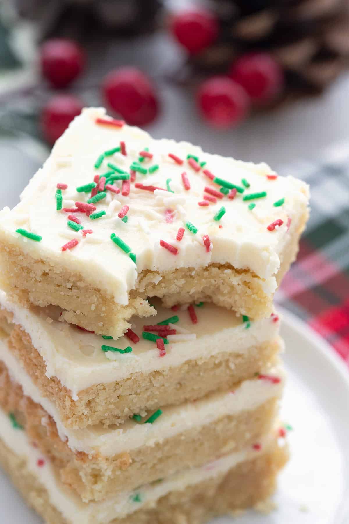 Close up shot of keto sugar cookie bars with a bite taken out of the top one.