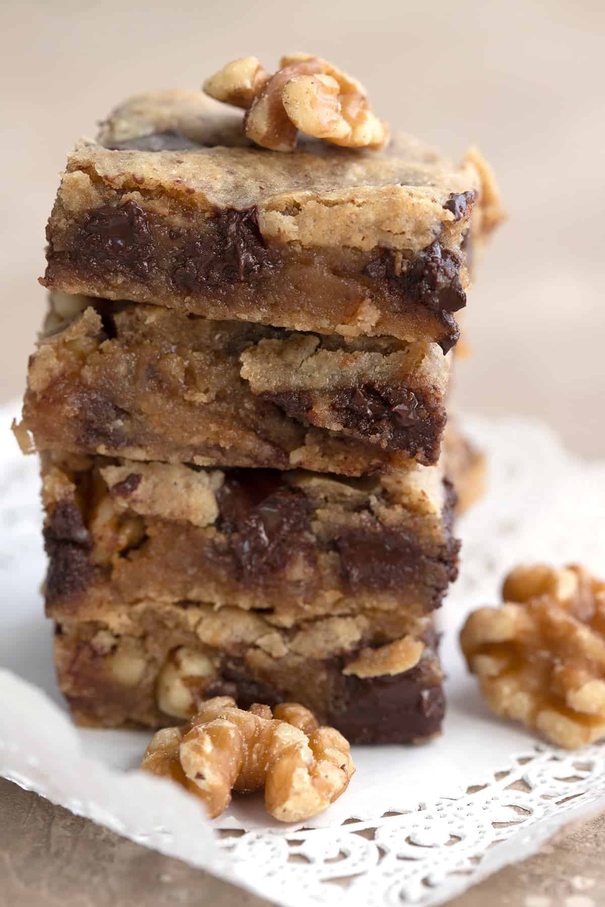 Close up shot of a stack of keto walnut blondies with chocolate chunks.