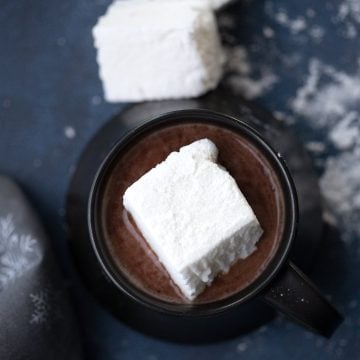 Top down image of a keto sugar free marshmallow in a cup of hot chocolate.