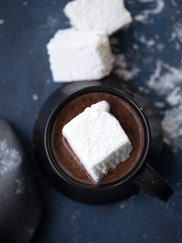 Top down image of a keto sugar free marshmallow in a cup of hot chocolate.