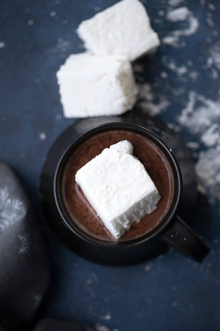 Top down image of a keto sugar free marshmallow in a cup of hot chocolate.