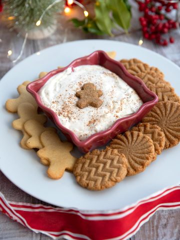 Keto Eggnog Dessert Dip in a red bowl surrounded by keto cookies.