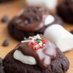 Titled image of Keto Hot Chocolate Cookies on a wooden cutting board with marshmallows and chocolate chips.