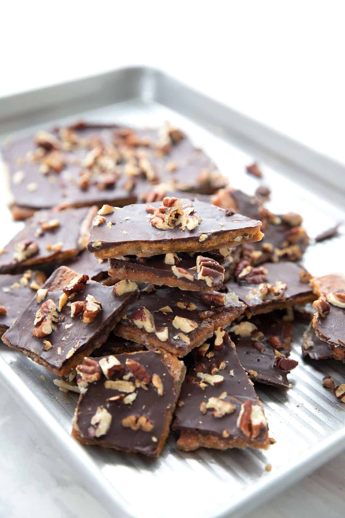 Keto cracker toffee piled up in a baking pan.