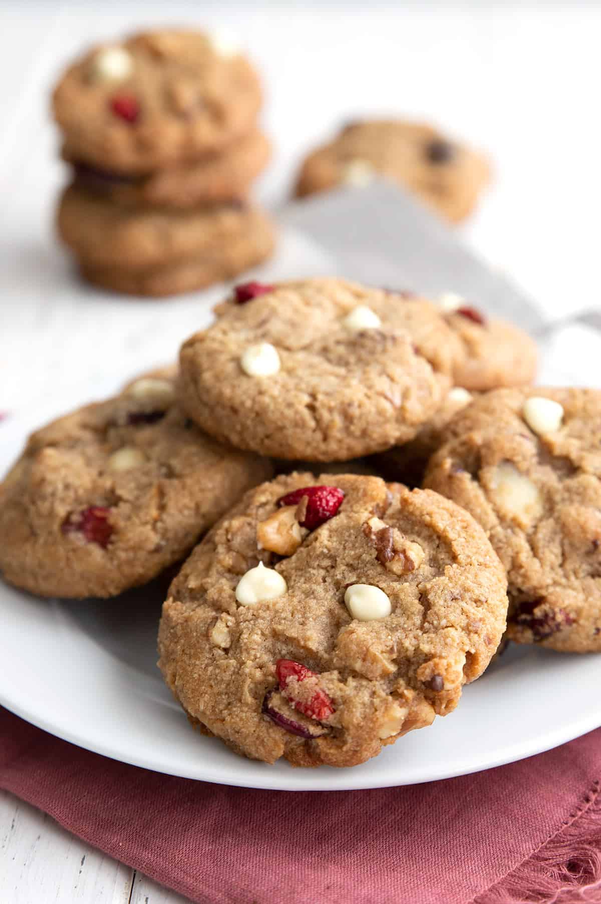 A plate of Keto White Chocolate Cranberry Cookies over a red napkin.