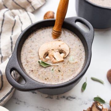 Keto Mushroom Soup in a black bowl with a spoon resting in it.