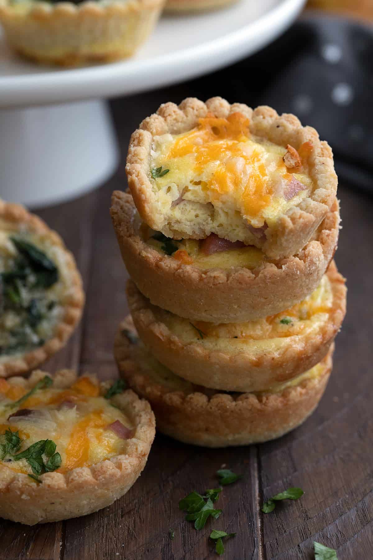 A stack of mini keto quiches with a bite taken out of the top one.