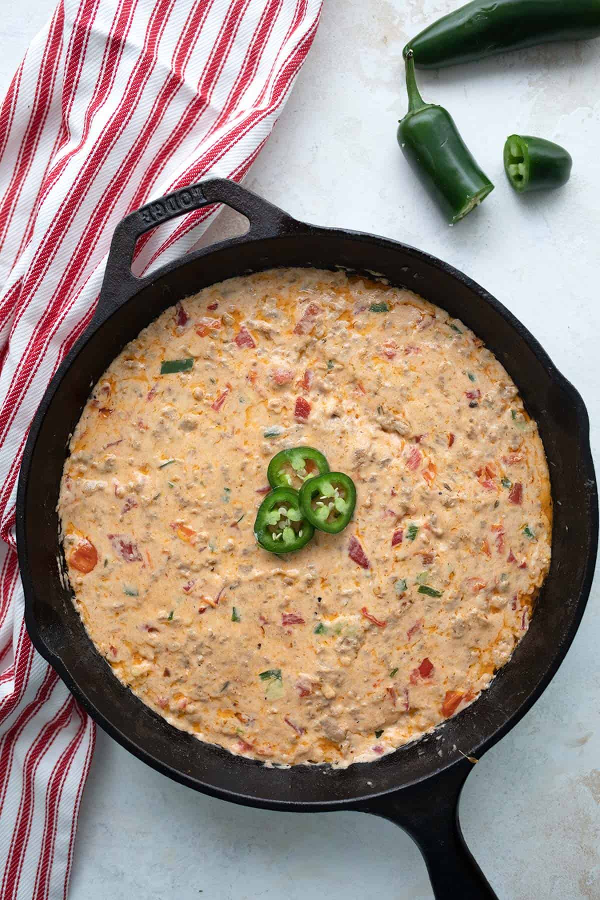 Top down image of Sausage Cheese Dip in a cast iron skillet.