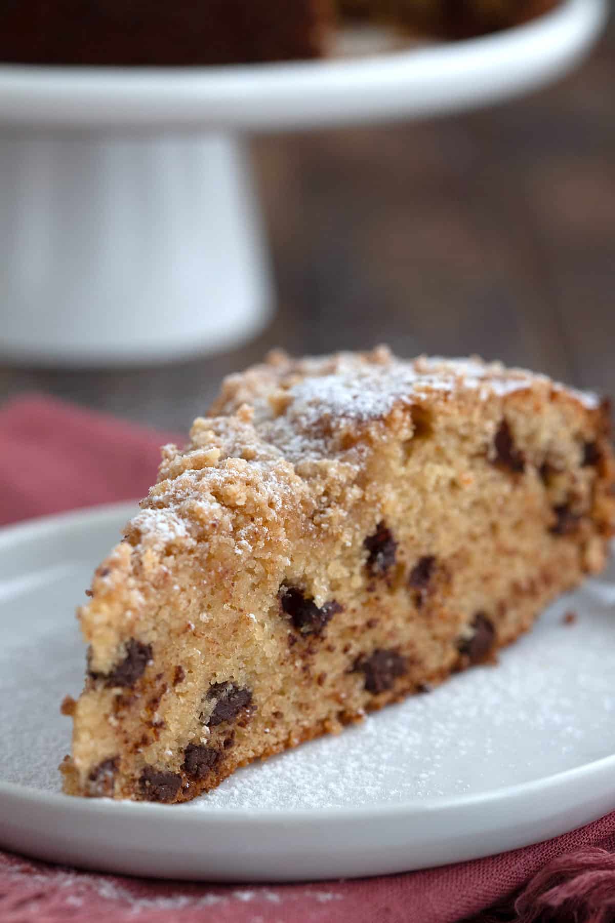 Close up shot of a slice of Keto Sour Cream Coffee Cake with chocolate chips.