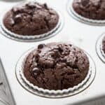 Close up shot of Chocolate Protein Muffins cooling in a muffin tin.