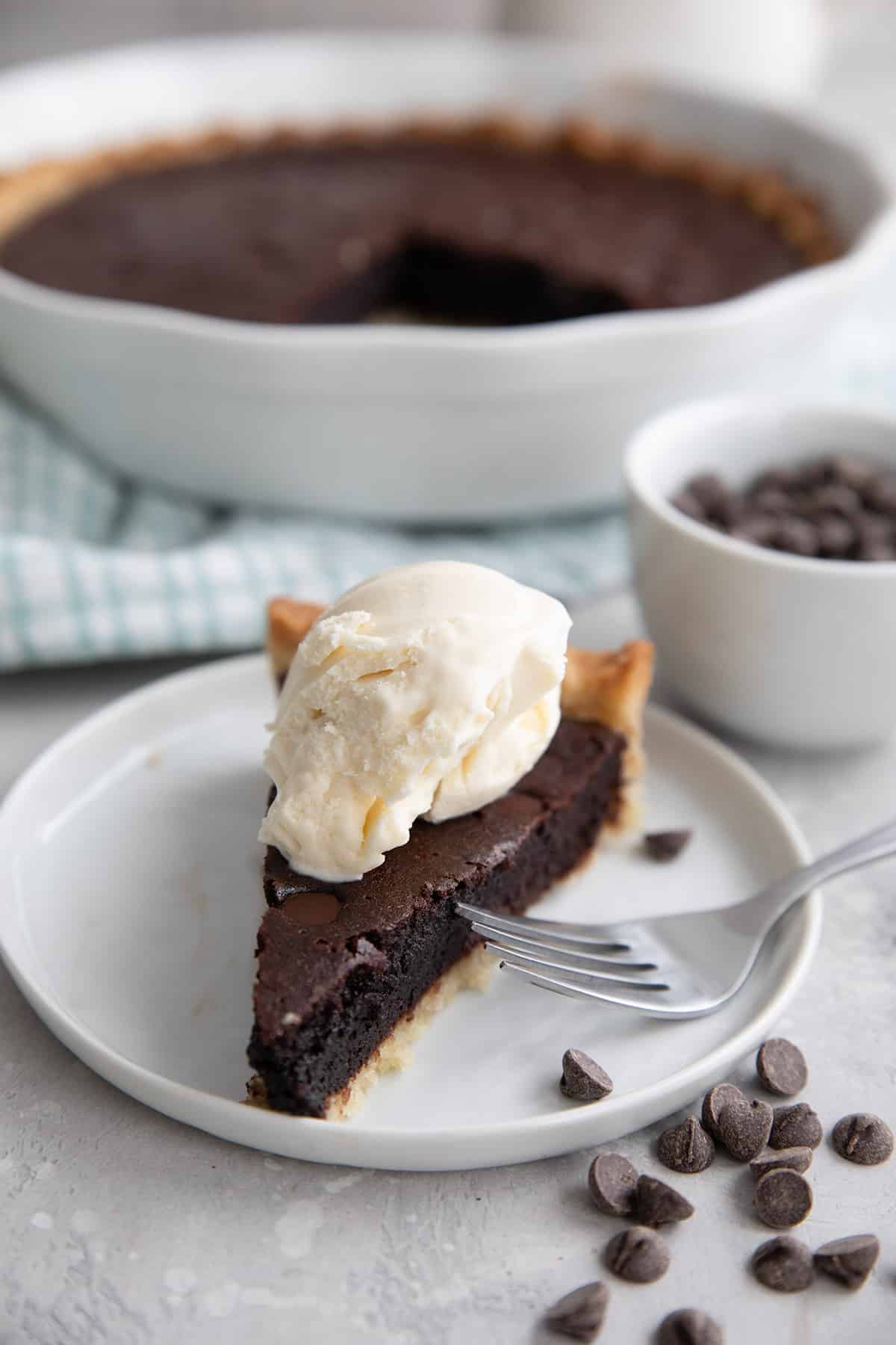 Keto brownie pie with a scoop of vanilla ice cream on top.