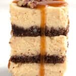 Titled Pinterest image of a stack of Keto Salted Caramel Cheesecake Bars.