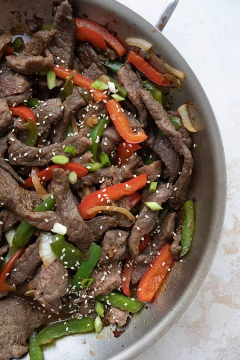 Top down image of keto pepper steak in a stainless steel skillet.