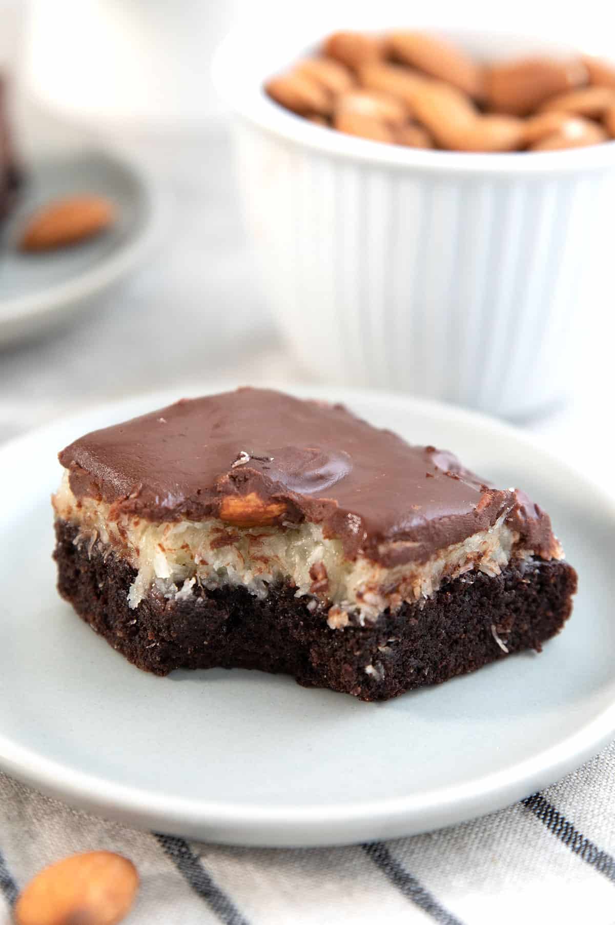 Close up shot of a keto almond joy brownie with a bite taken out of it.