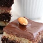 Titled image of a keto almond joy brownie on a white table.