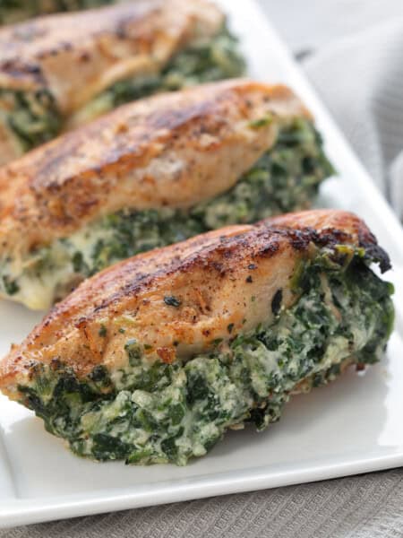 Spinach Stuffed Chicken Breasts on a white rectangular platter.