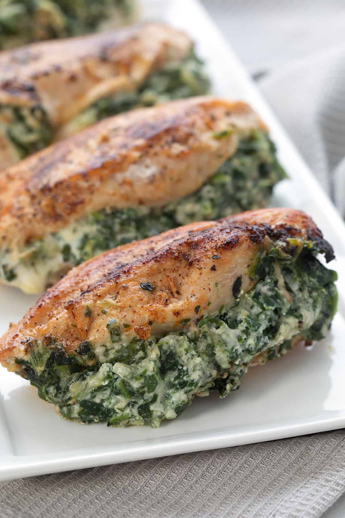 Spinach Stuffed Chicken Breasts on a white rectangular platter.