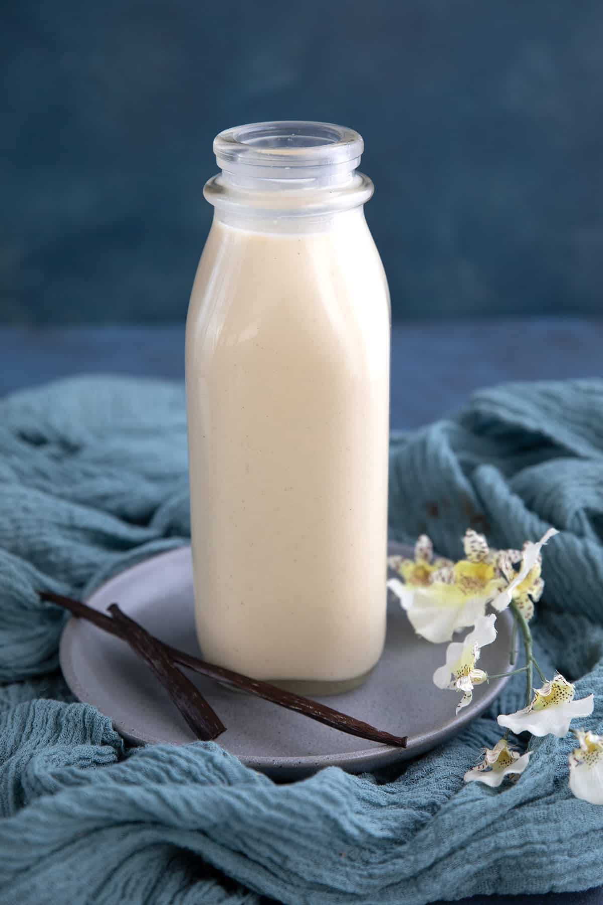 A glass bottle filled with homemade low carb coffee creamer.