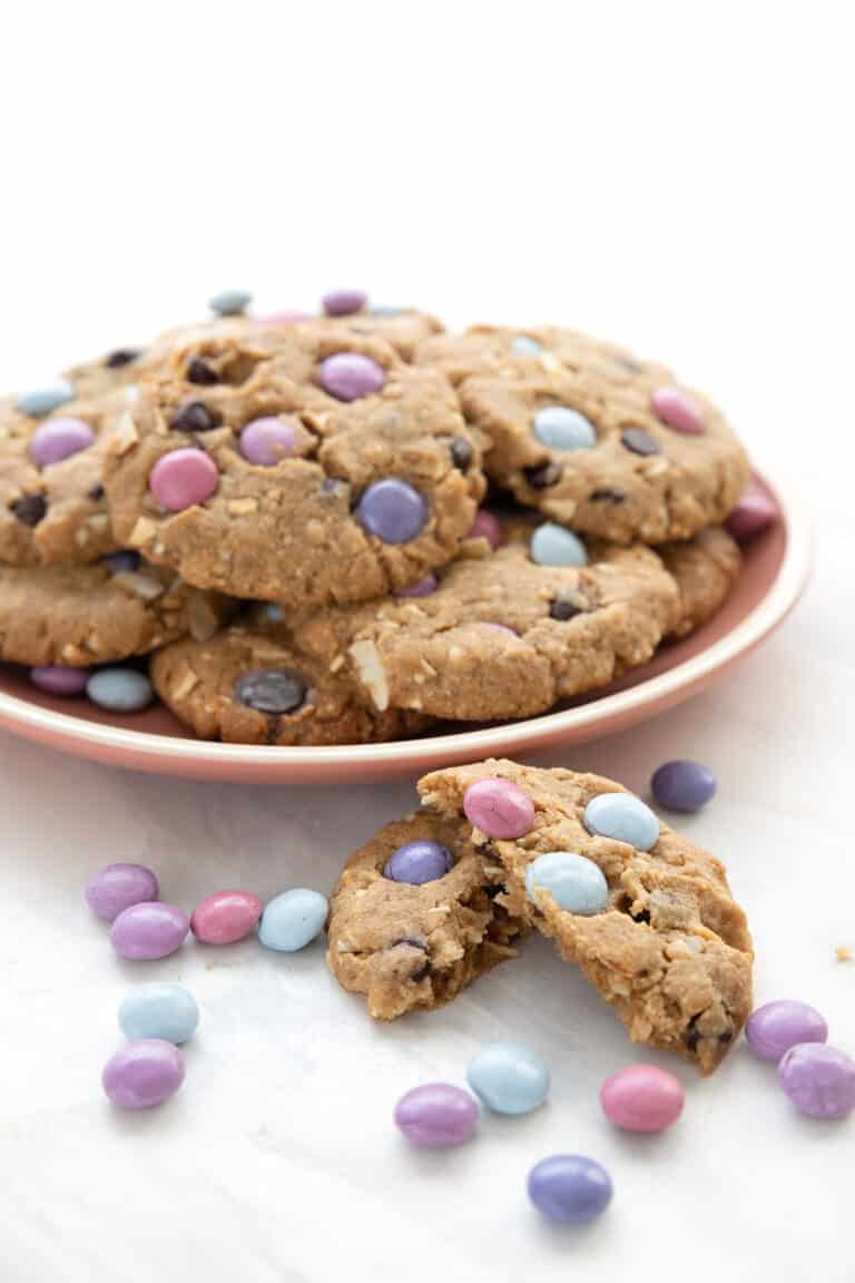 A pink plate full of Keto Cookies with candy pieces.