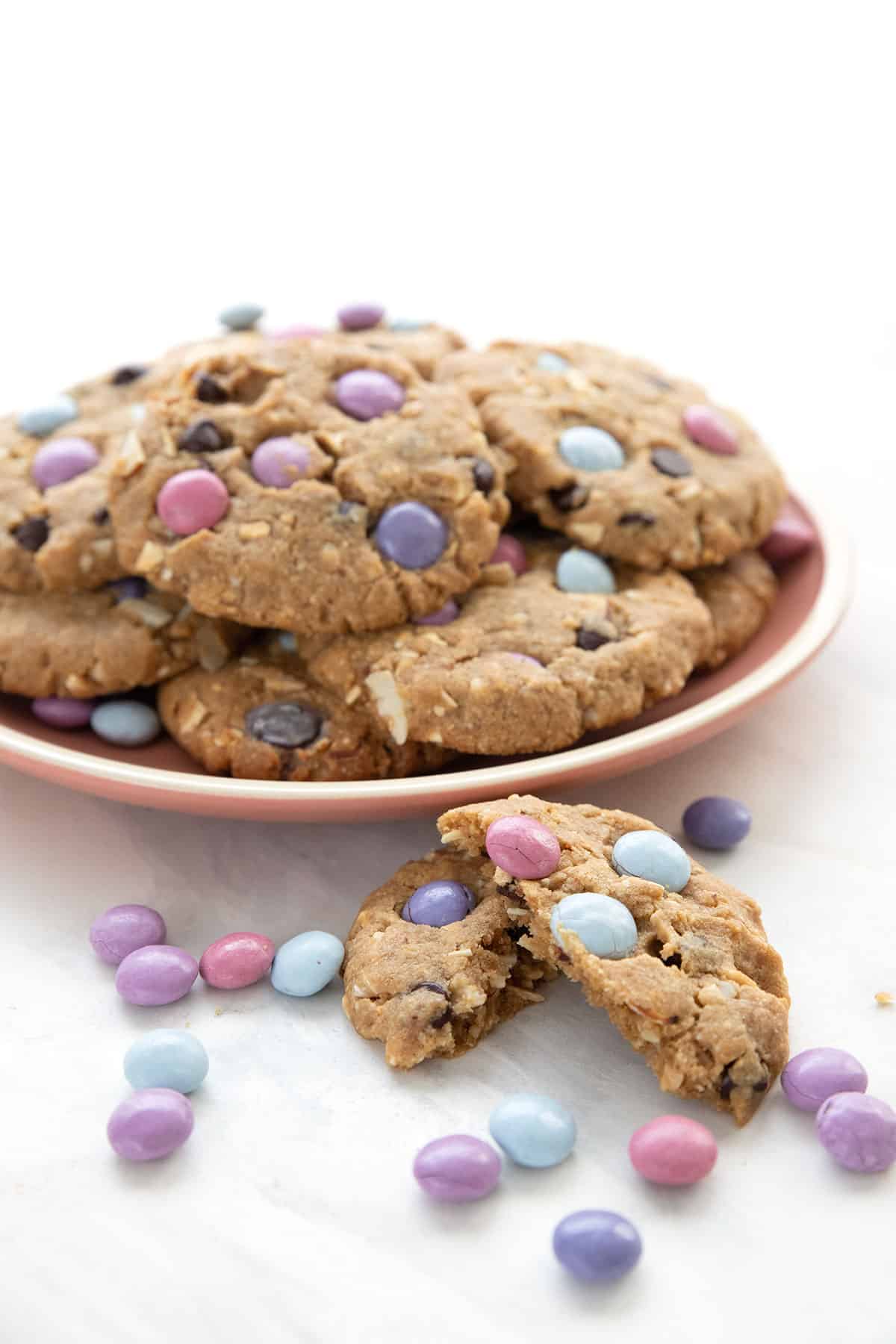 A pink plate full of Keto Cookies with candy pieces.